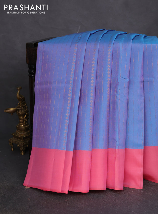 Kanchipuram silk saree dual shade of blue and peach pink with allover copper zari weaves and simple border