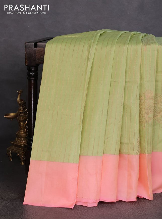 Kanchipuram silk saree pista green and peach pink with allover copper zari weaves and simple border