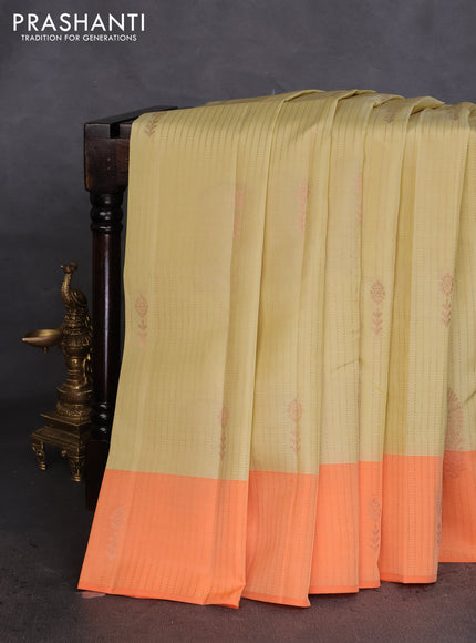 Kanchipuram silk saree cream and orange with allover copper zari weaves & buttas and copper zari woven border