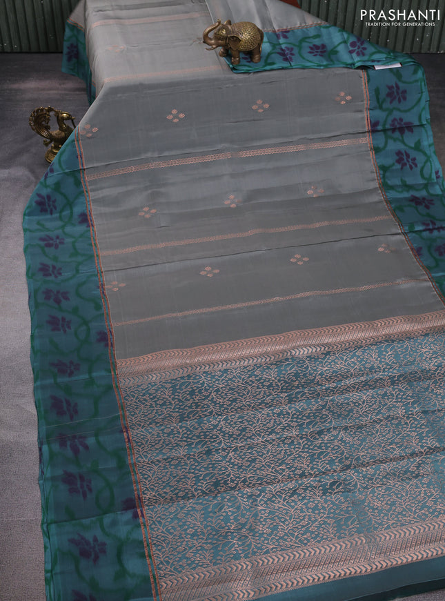 Kanchipuram silk saree grey and teal green shade with allover copper zari weaves and zari woven ikat style border