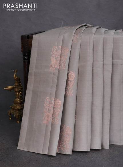 Kanchipuram silk saree grey and dual shade of pinkish orange with copper zari woven floral buttas in borderless style