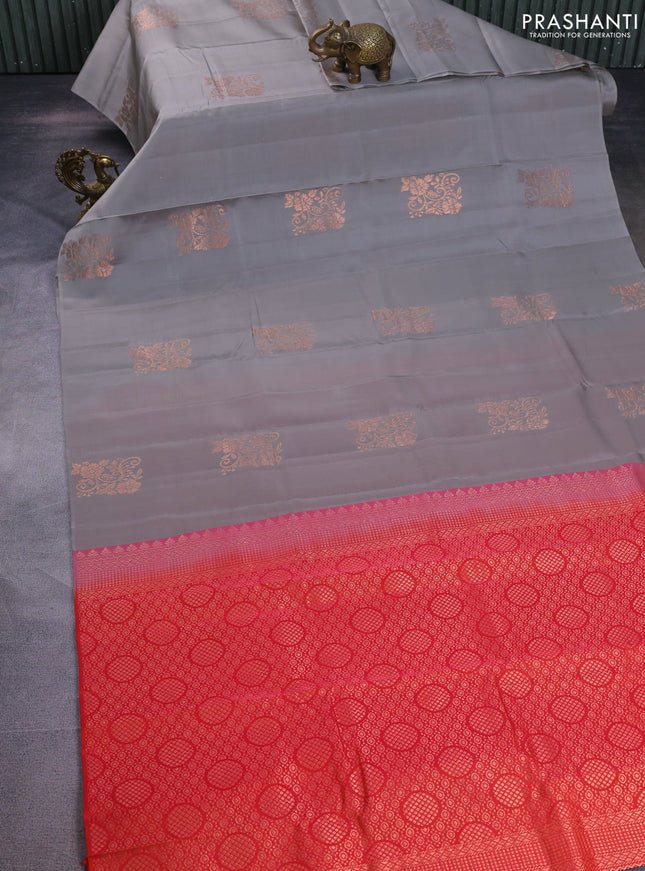 Kanchipuram silk saree grey and dual shade of pinkish orange with copper zari woven floral buttas in borderless style
