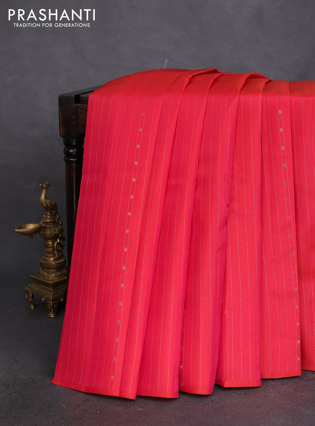 Kanchipuram silk saree dual shade of pinkish orange and teal blue with allover zari weaves in borderless style