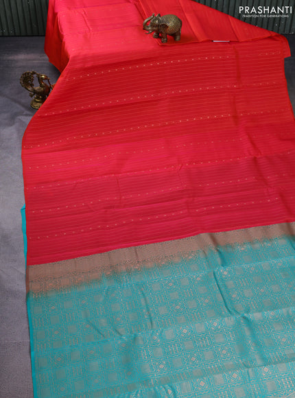 Kanchipuram silk saree dual shade of pinkish orange and teal blue with allover zari weaves in borderless style