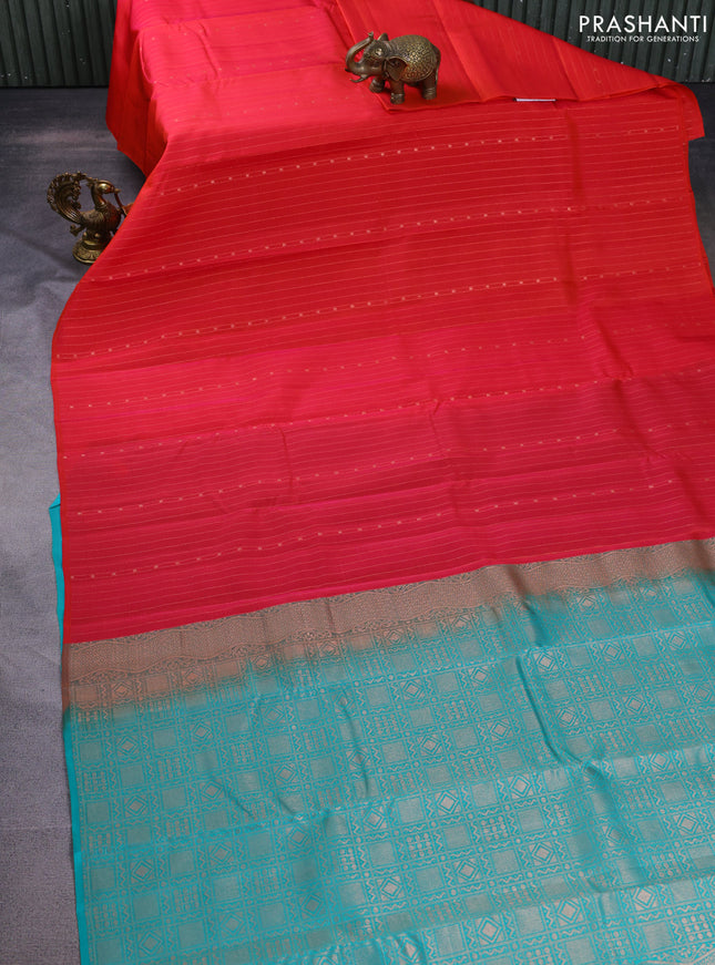 Kanchipuram silk saree dual shade of pinkish orange and teal blue with allover zari weaves in borderless style