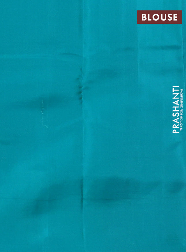 Kanchipuram silk saree dual shade of pinkish orange and teal blue with allover zari weaves in borderless style