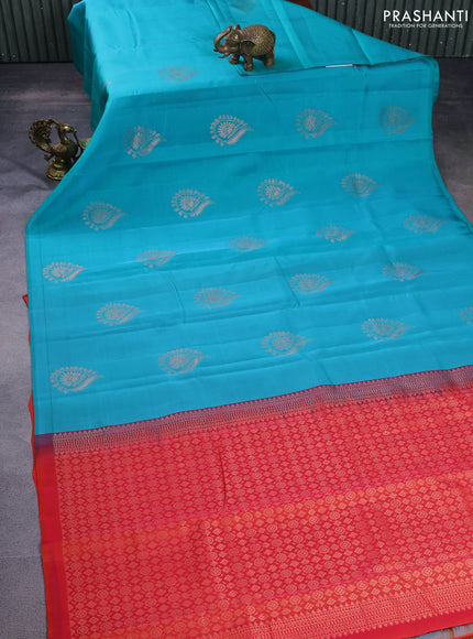 Kanchipuram silk saree teal blue and pinkish orange with copper zari woven buttas in borderless style