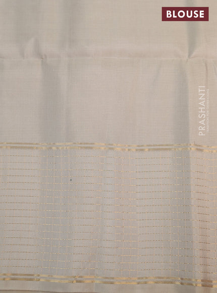 Pure soft silk saree green and beige with allover zari woven buttas and zari woven checked border