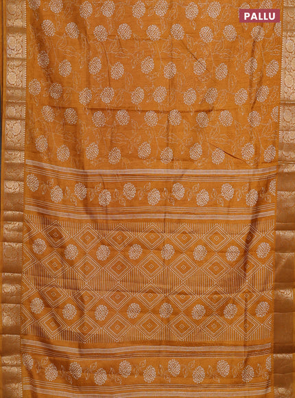 Semi dola saree mustard yellow with floral prints & self emboss and zari woven border