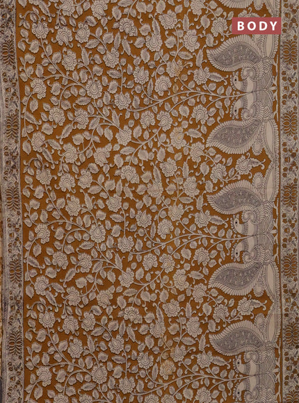 Kalamkari cotton saree dark mustard and beige with allover prints and printed border