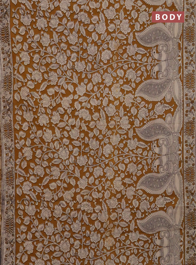 Kalamkari cotton saree dark mustard and beige with allover prints and printed border
