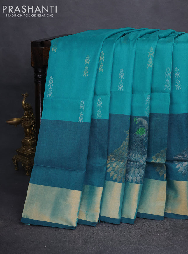 Pure uppada silk saree teal blue and black with allover silver & gold zari woven buttas and long zari woven peacock butta border