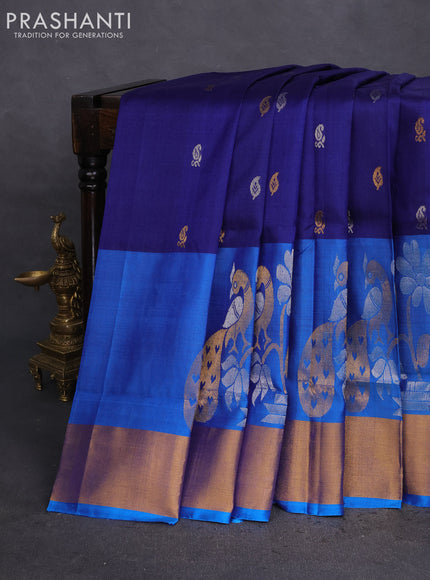 Pure uppada silk saree dark blue and cs blue with allover silver & gold zari weaves and long peacock design zari woven border