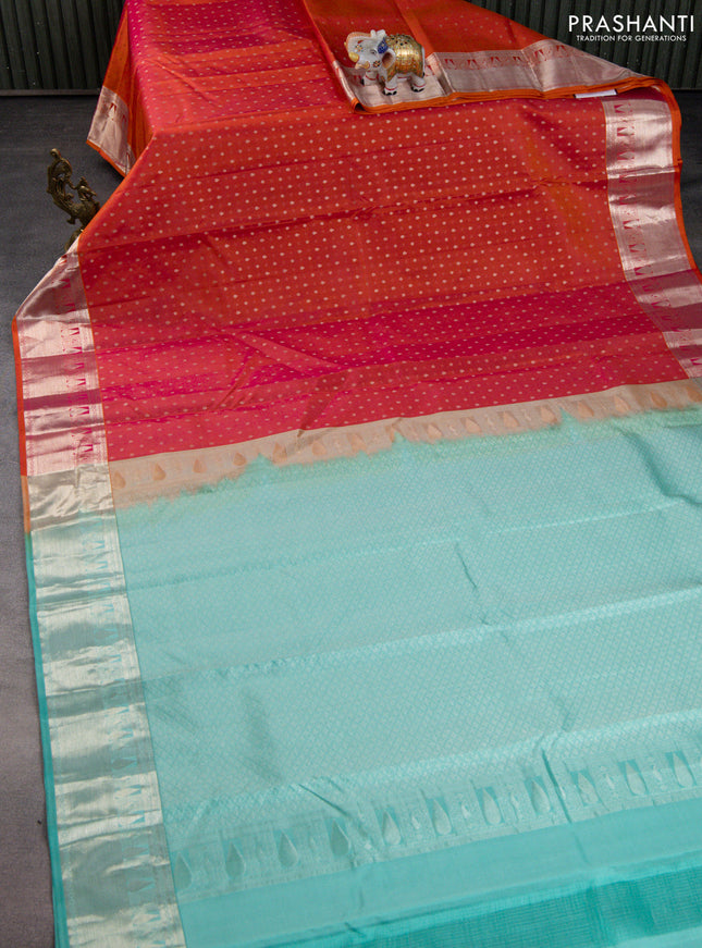 Pure kanchipuram silk saree dual shade of pinksh orange and teal blue with allover silver zari woven 1000 butta weaves and rich zari woven border