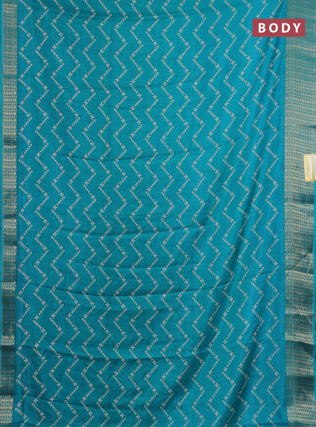 Semi dola saree teal blue with allover zig zag prints and zari woven border
