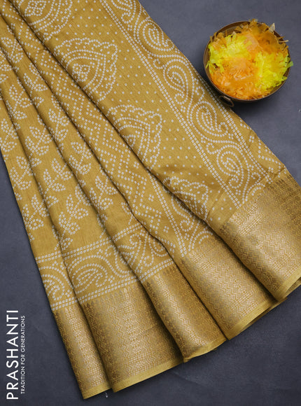 Semi dola saree yellow with allover bandhani prints and zari woven border