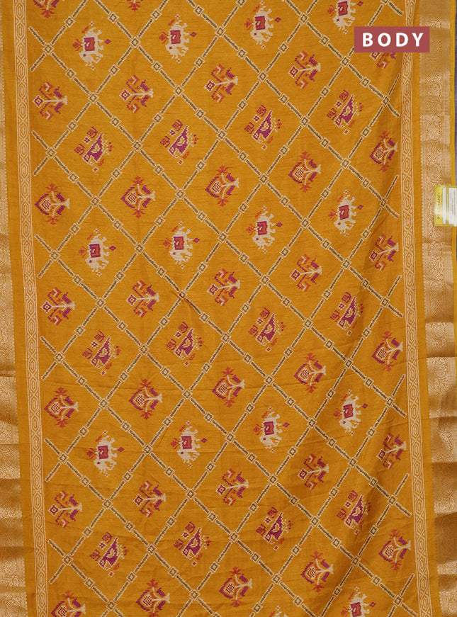 Semi dola saree mustard yellow with allover patola prints and zari woven border