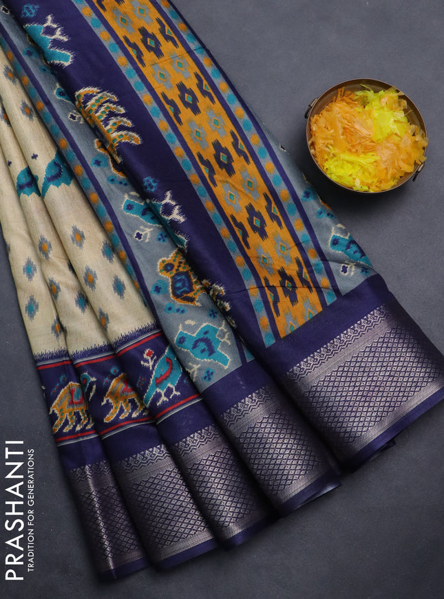 Semi dola saree cream and navy blue with allover patola prints and zari woven border