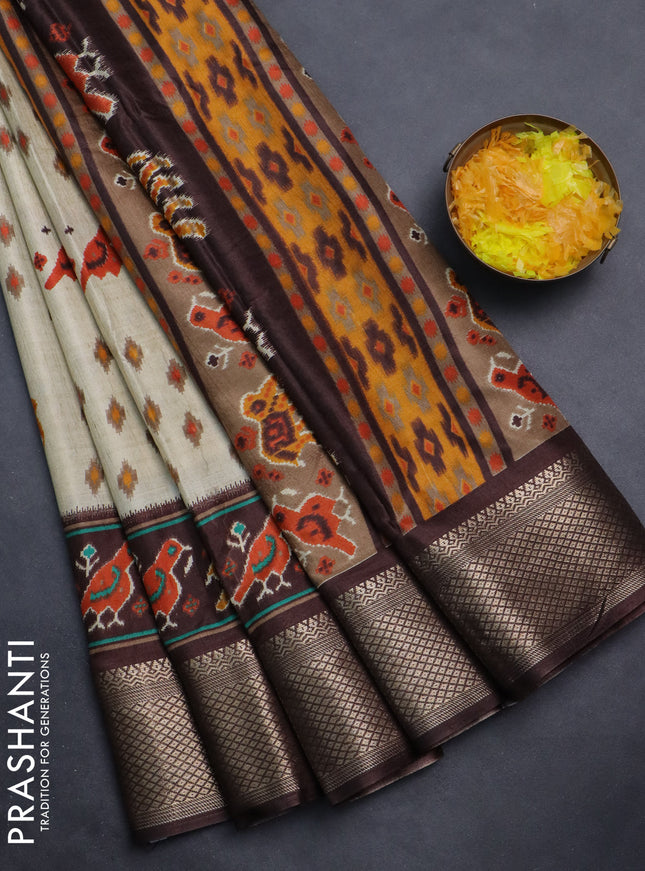 Semi dola saree cream and brown with allover patola prints and zari woven border