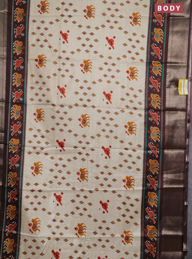 Semi dola saree cream and brown with allover patola prints and zari woven border