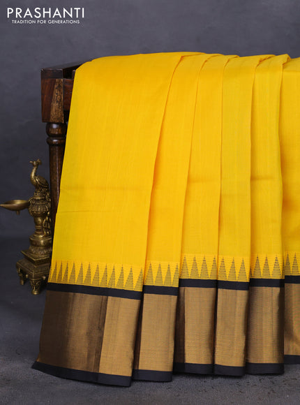Kuppadam silk cotton saree yellow and black with plain body and temple design zari woven border