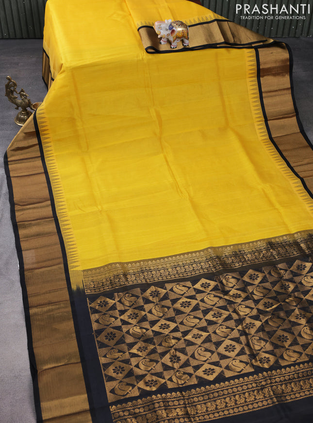 Kuppadam silk cotton saree yellow and black with plain body and temple design zari woven border