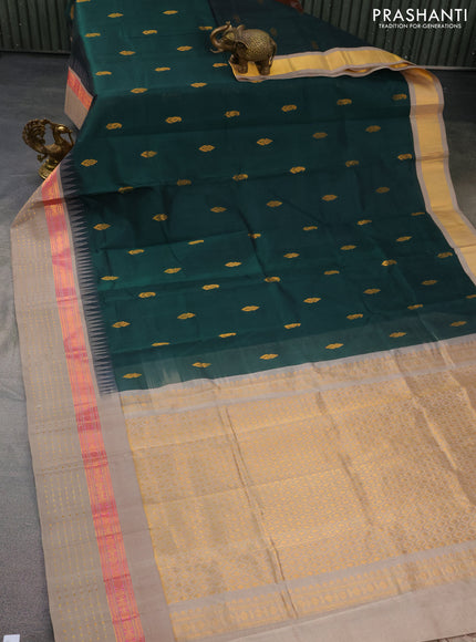 Kuppadam silk cotton saree bottle green and grey shade with zari woven buttas and temple design zari woven border