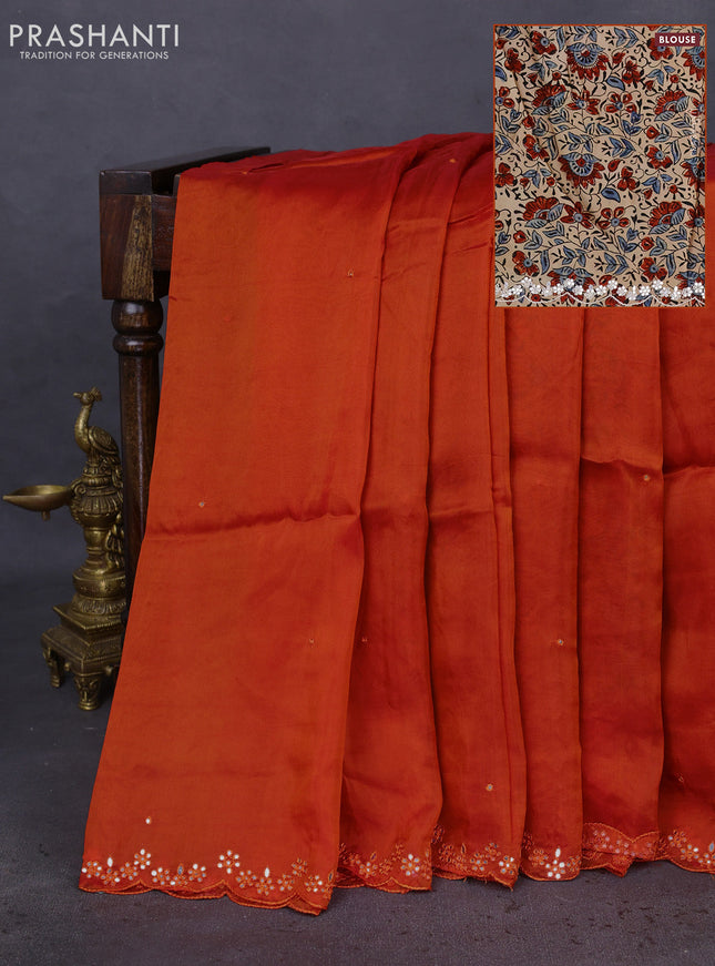 Satin crepe silk saree orange and beige with mirror work and ajrakh printed blouse