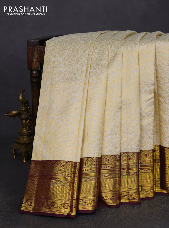 Pure kanchipuram silk saree cream and deep wine shade with allover zari woven brocade weaves and zari woven border