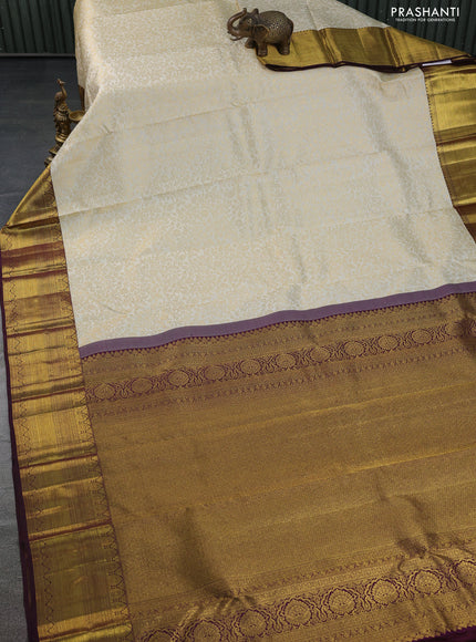 Pure kanchipuram silk saree cream and deep wine shade with allover zari woven brocade weaves and zari woven border