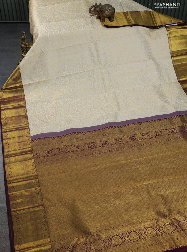 Pure kanchipuram silk saree cream and deep wine shade with allover zari woven brocade weaves and zari woven border