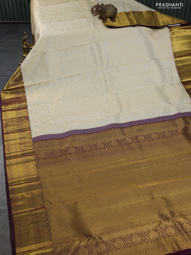 Pure kanchipuram silk saree cream and deep wine shade with allover zari woven brocade weaves and zari woven border