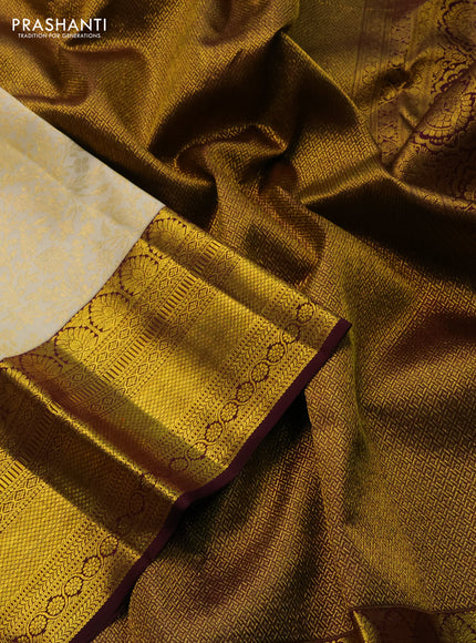 Pure kanchipuram silk saree cream and deep wine shade with allover zari woven brocade weaves and zari woven border
