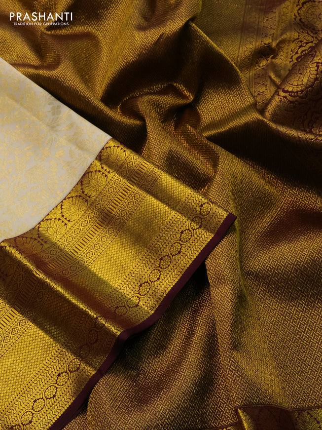 Pure kanchipuram silk saree cream and deep wine shade with allover zari woven brocade weaves and zari woven border