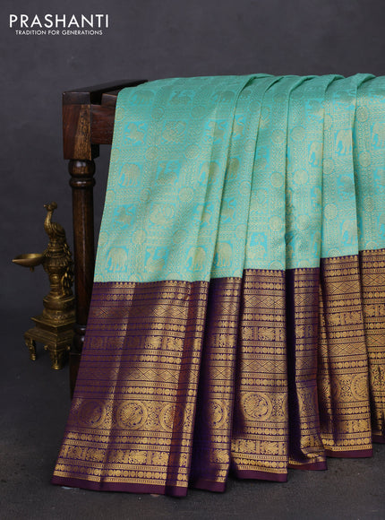 Pure kanchipuram silk saree teal blue and deep jamun with allover zari woven brocade weaves and long zari woven border