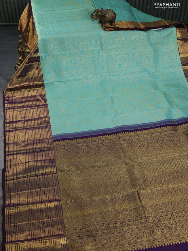 Pure kanchipuram silk saree teal blue and deep jamun with allover zari woven brocade weaves and long zari woven border