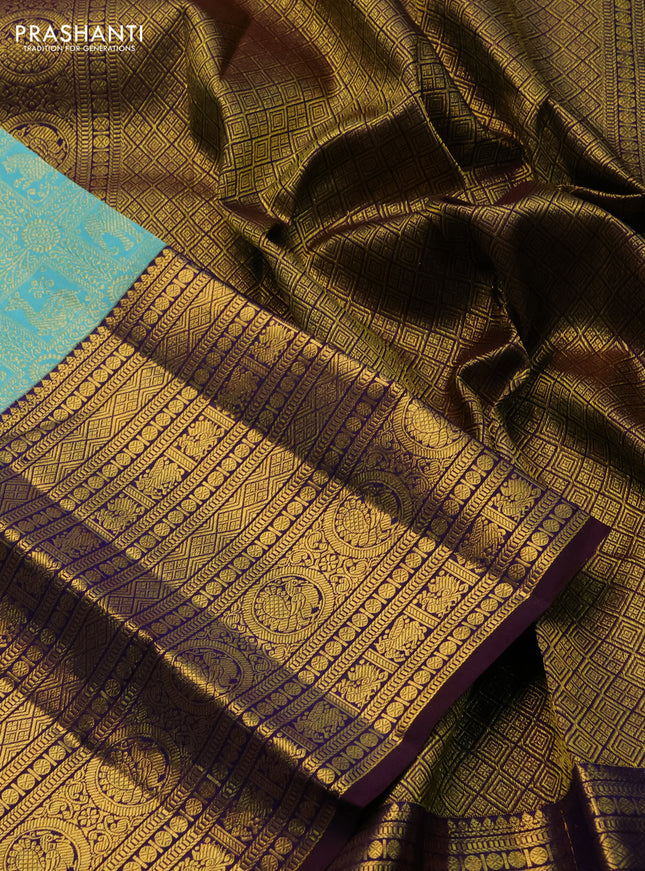 Pure kanchipuram silk saree teal blue and deep jamun with allover zari woven brocade weaves and long zari woven border