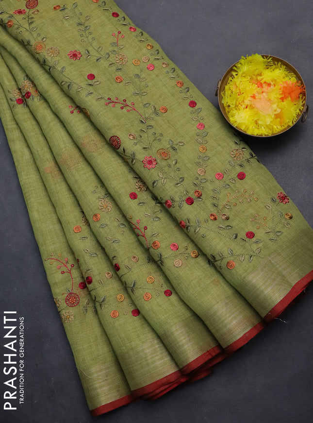 linen cotton saree light green and red with embroidery buttas and zari woven border