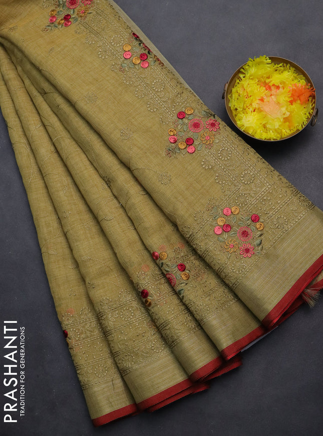 linen cotton saree mustrad green and red with allover embroidery work and zari woven border