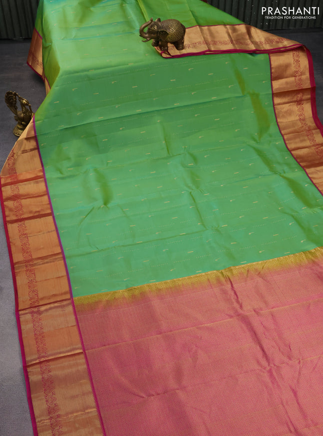 Pure kanchipuram silk saree dual shade of green and magenta pink with allover zari woven muniya buttas and rich zari woven border