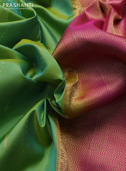 Pure kanchipuram silk saree dual shade of green and magenta pink with allover zari woven muniya buttas and rich zari woven border