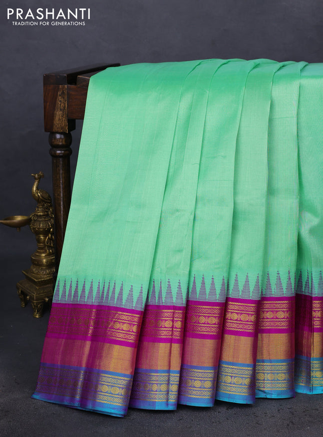 Kuppadam silk cotton saree teal green shade and purple with plain body and temple design zari woven border