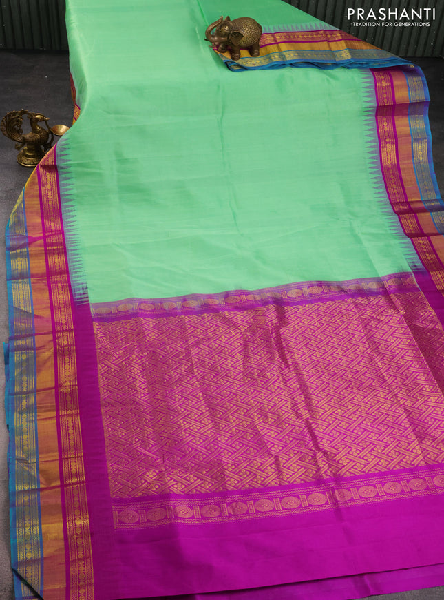 Kuppadam silk cotton saree teal green shade and purple with plain body and temple design zari woven border