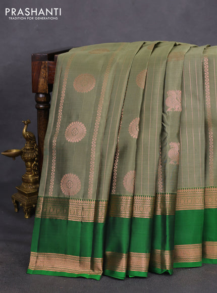 Kanchipuram silk saree elaichi green and green with allover copper zari weaves & buttas and rettapet copper zari woven border