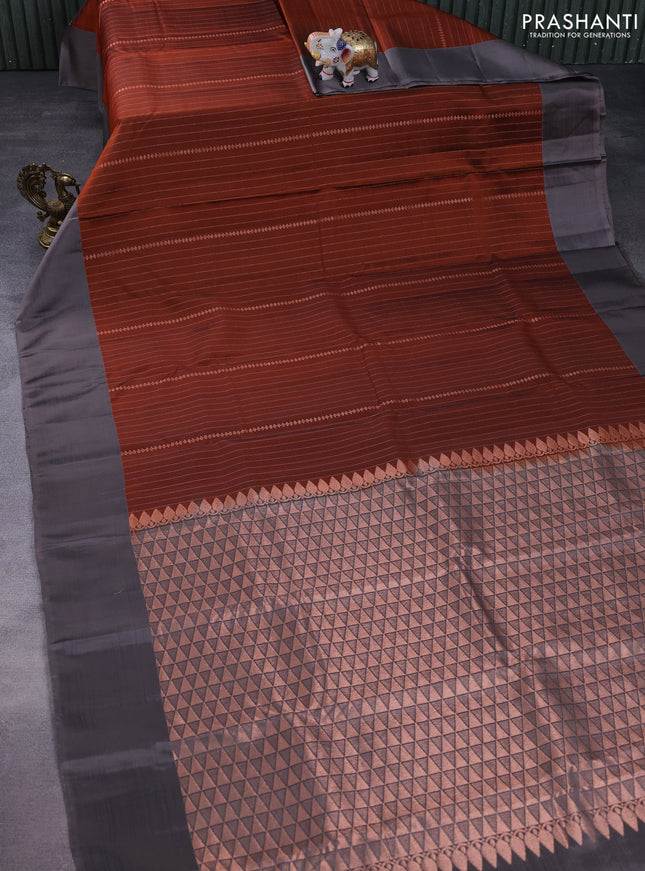 Kanchipuram silk saree rust shade and grey with allover copper zari weaves and simple border