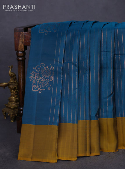 Kanchipuram silk saree peacock blue and dark mustard with allover copper zari weaves and simple border