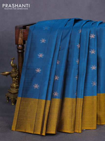Kanchipuram silk saree peacock blue and dark mustard with copper zari woven buttas and self emboss border