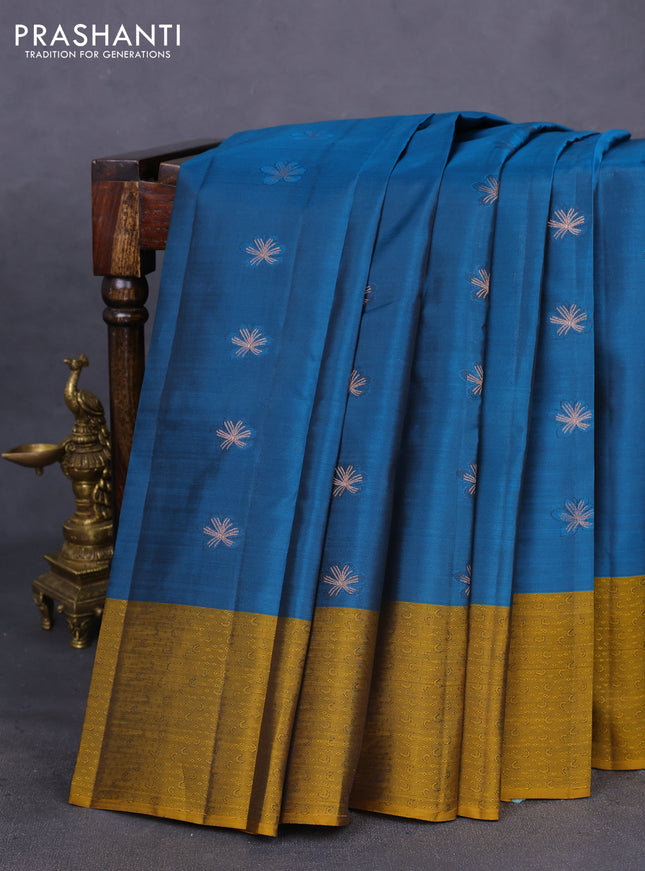 Kanchipuram silk saree peacock blue and dark mustard with copper zari woven buttas and self emboss border