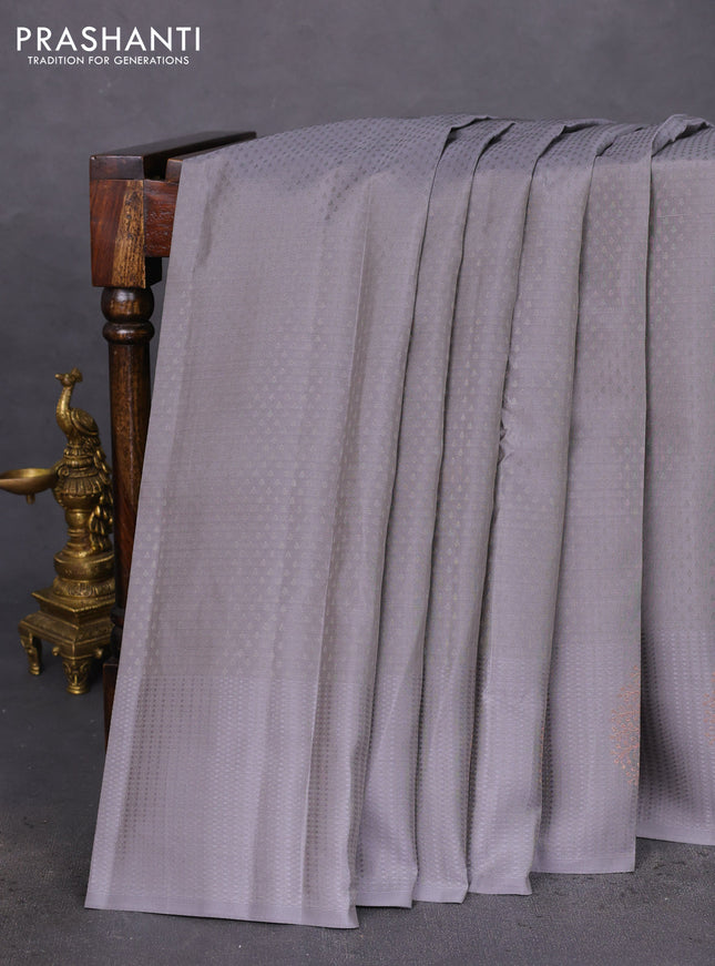 Kanchipuram silk saree grey and teal blue with allover self emboss and copper zari woven buttas