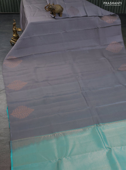Kanchipuram silk saree grey and teal blue with allover self emboss and copper zari woven buttas